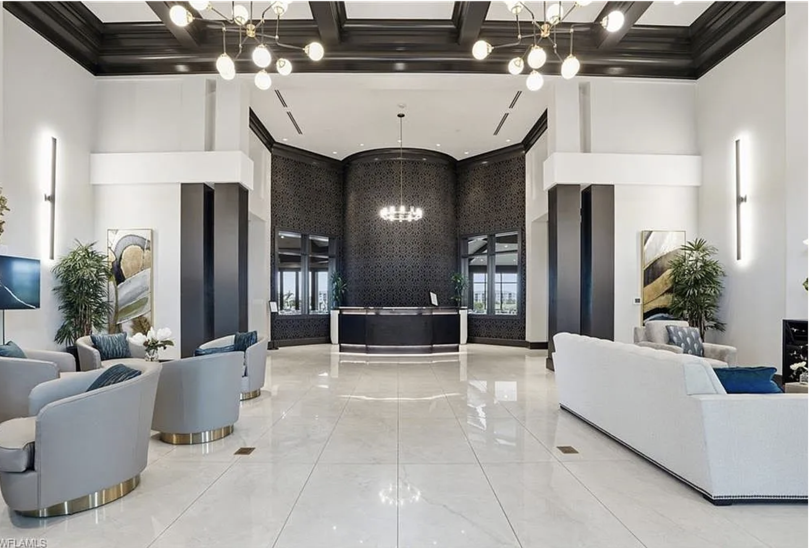 The sophisticated lobby welcomes arrivals with soaring coffered ceilings, designer lighting, and plush seating areas—a refined introduction to the property.