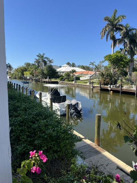 Tranquil canal views from your private dock, framed by swaying palms and lush tropical gardens—the perfect setting for morning coffee or an evening glass of wine.