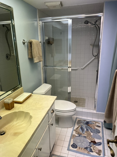 Step out of the shower onto soft tile floors in your private bathroom, where fresh towels and a full vanity await after your morning rinse.