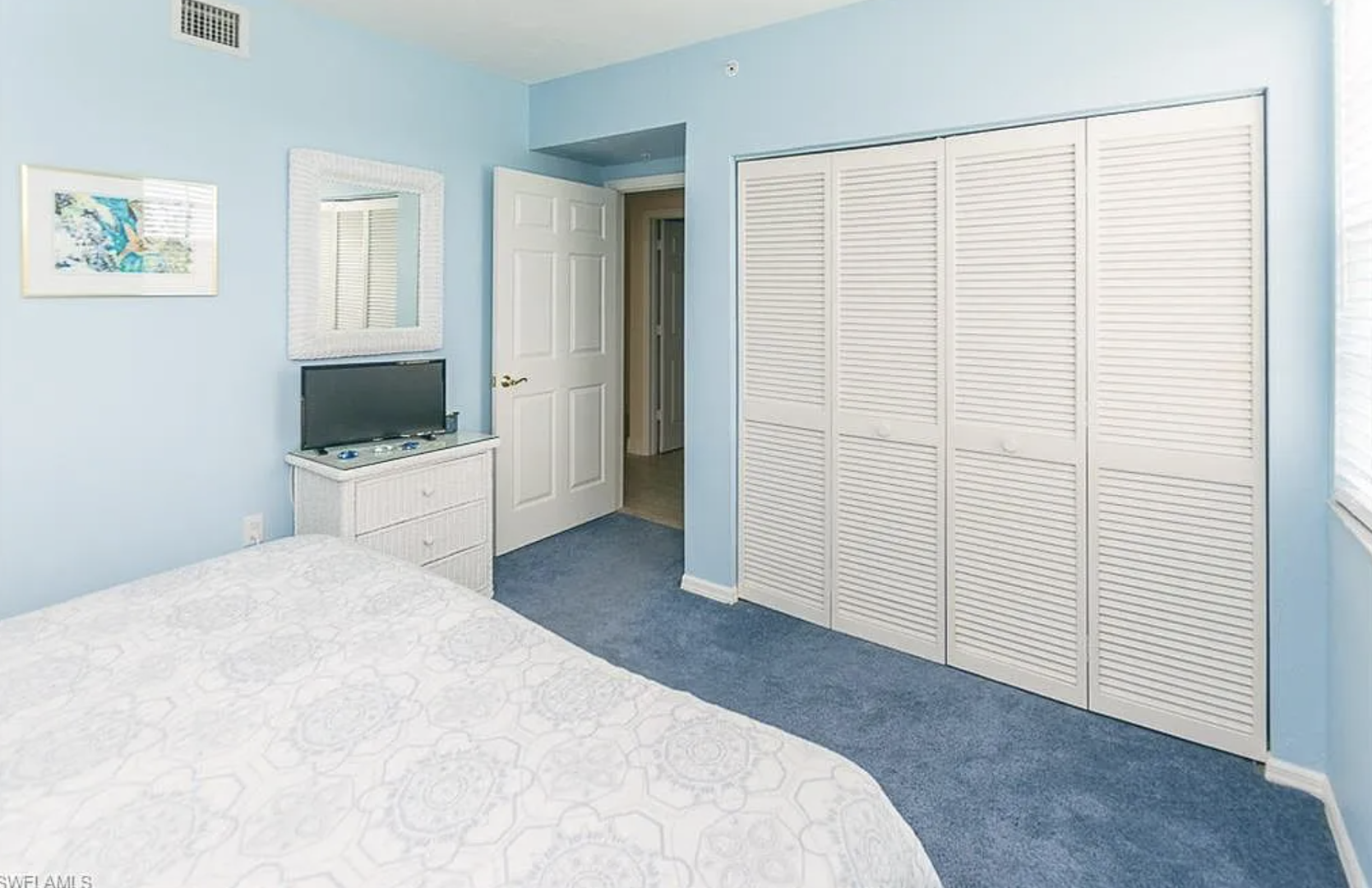 Your serene bedroom offers plenty of storage space with built-in closets and coastal-inspired décor, creating a peaceful retreat for restful nights.