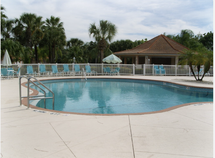 Sparkling pool area surrounded by tropical palms and comfortable seating  4 community pools to enjoy