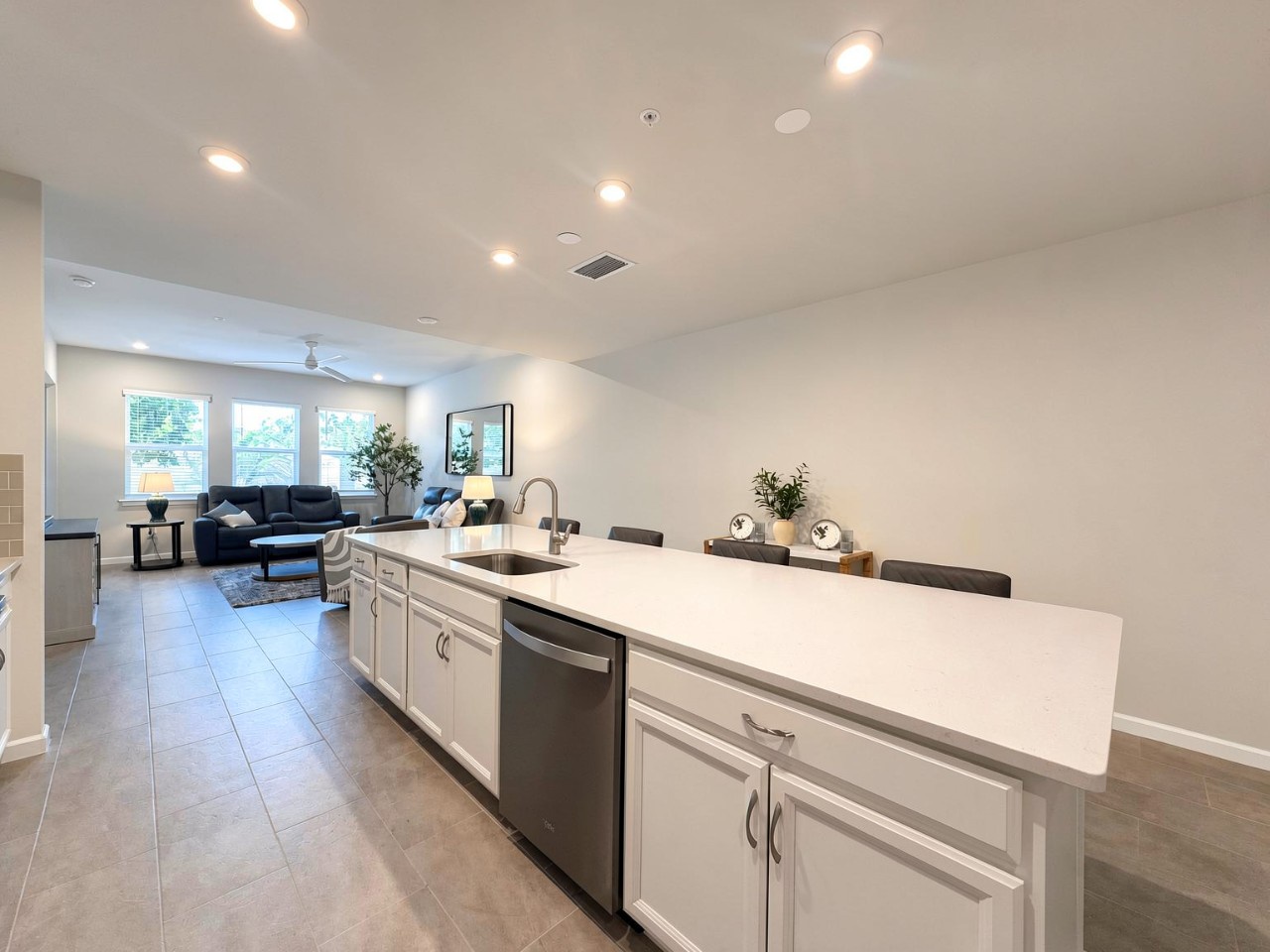 Modern kitchen with sleek countertops, spacious island, and stainless appliances. The bright, airy space is perfect for cooking and entertaining in your home away from home.