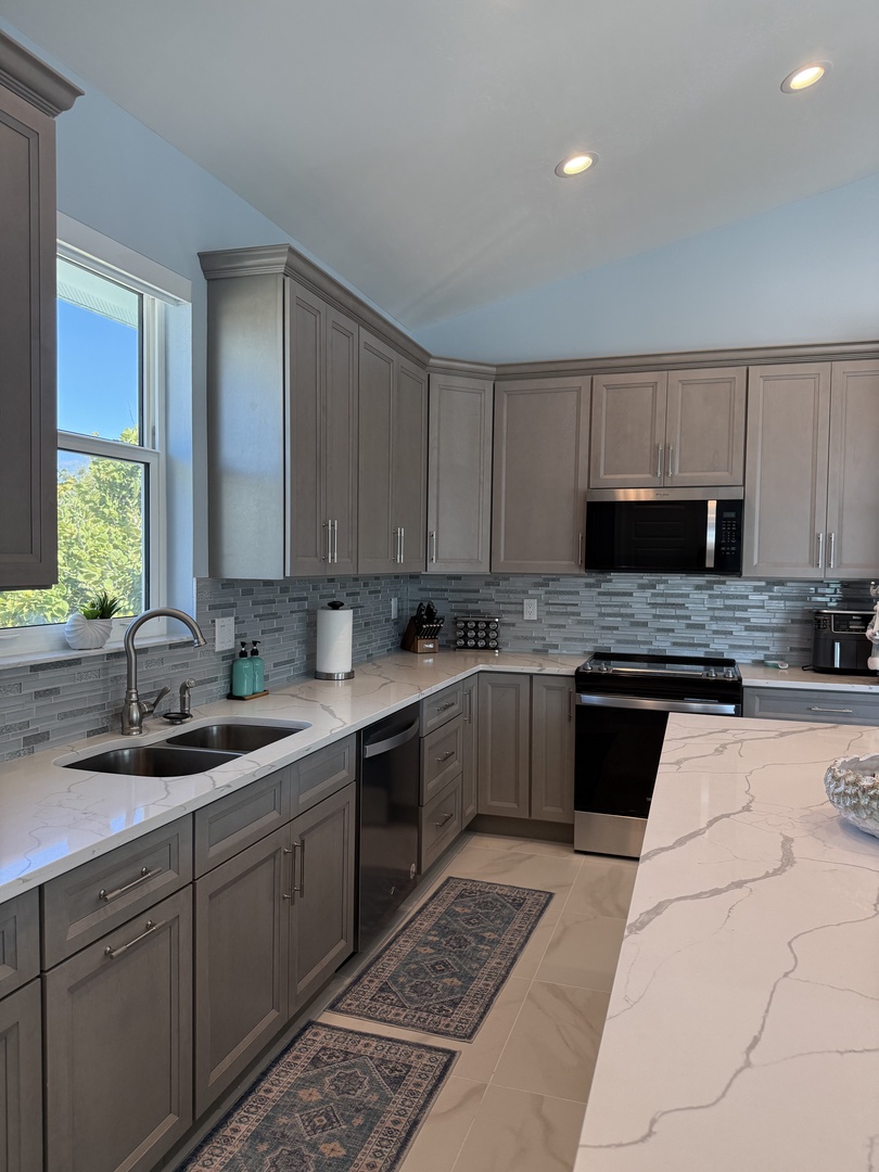 Your elegant kitchen features modern appliances, marble countertops, and gleaming finishes for effortless meal preparation.