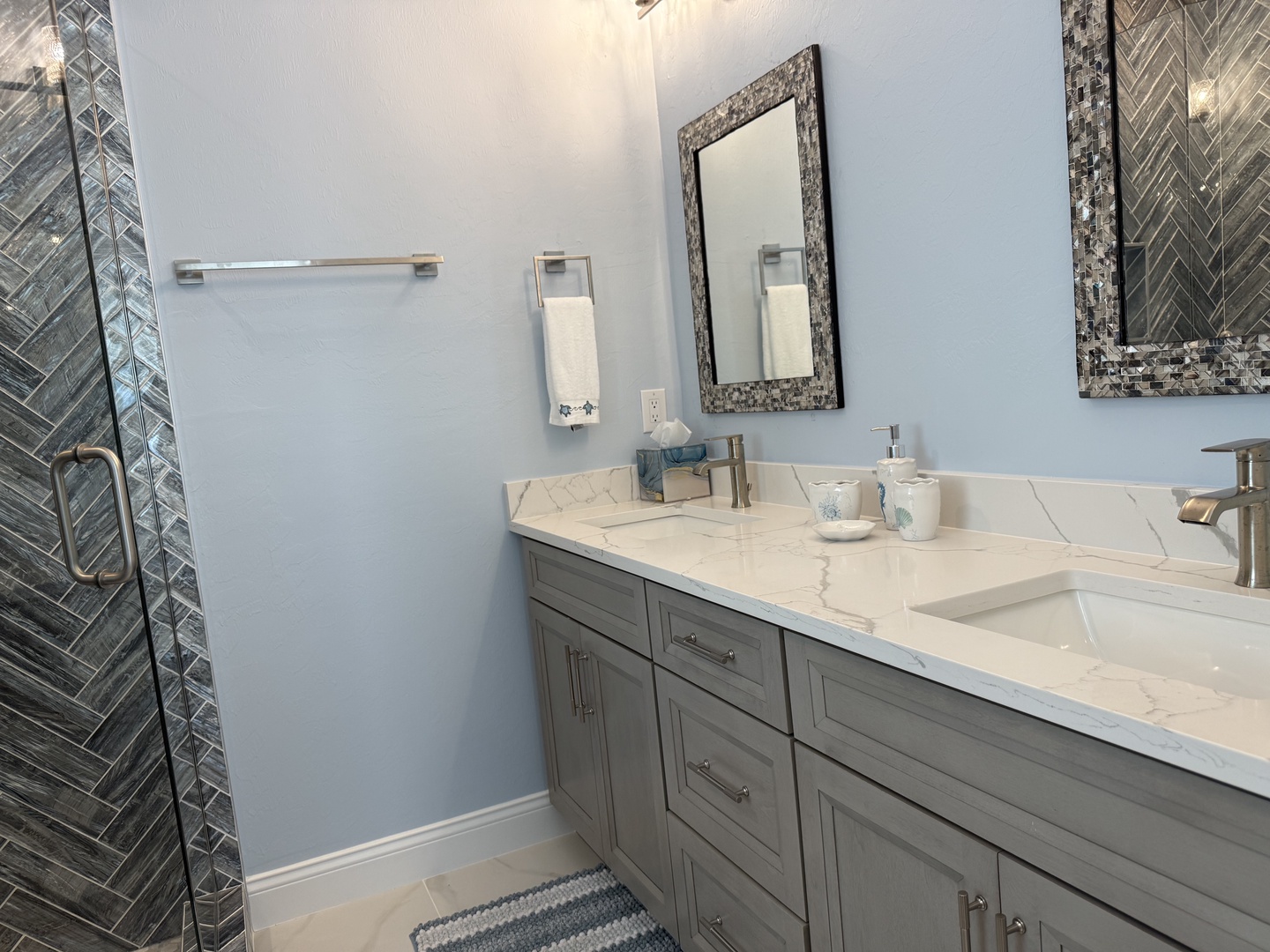 Luxuriate in your elegantly appointed bathroom featuring marble countertops, dual vanities, and stunning mosaic tile accents that create a spa-like retreat.
