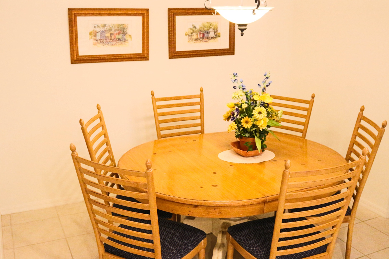 Gather around your welcoming dining table for memorable meals with loved ones in this warm, inviting space.