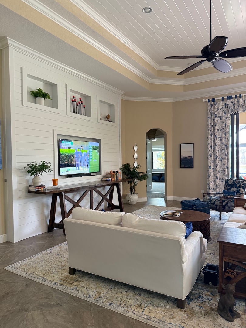 Your bright living space features a cozy white sofa, built-in shelving, and warm wood accents—perfect for relaxing after exploring.