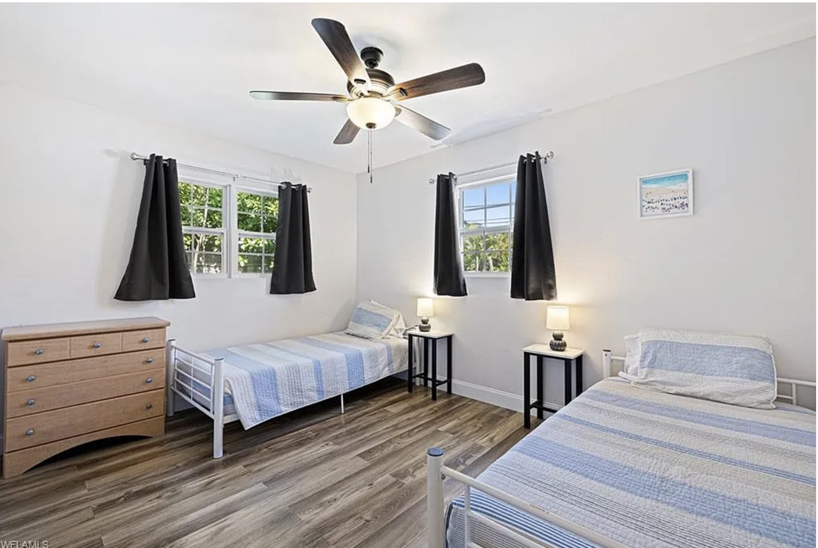 Bright and airy guest room with twin beds, perfect for flexible sleeping arrangements. Cool ceiling fan keeps you comfortable year-round.