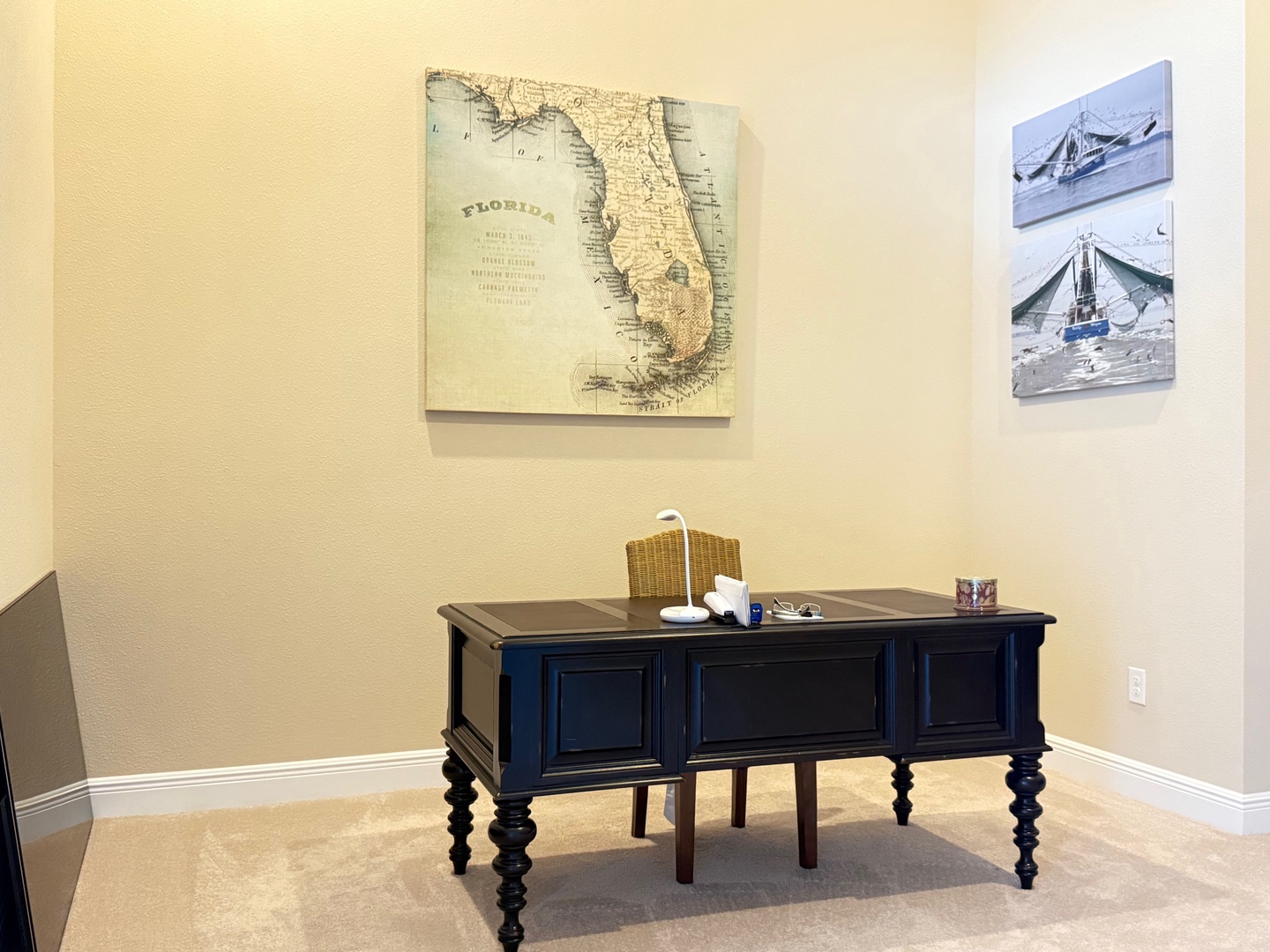 Your private workspace features a charming vintage desk where you can plan adventures or catch up on work, surrounded by inspiring coastal artwork.