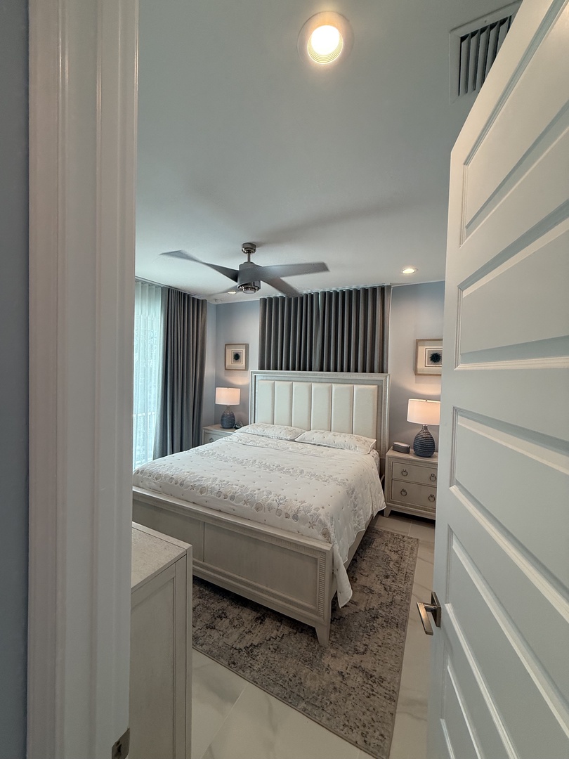 Your elegant bedroom features exposed beams, plush bedding, and soft lighting for the perfect restful retreat.