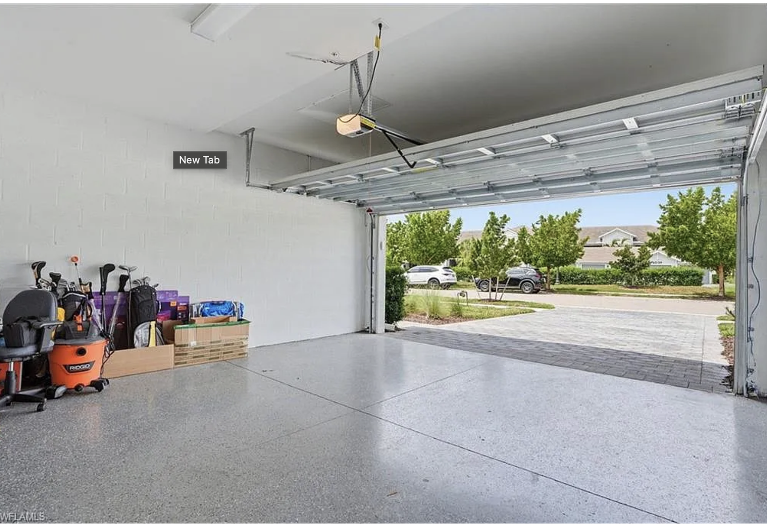 A spacious garage awaits, with convenient access to the quiet residential neighborhood just beyond.