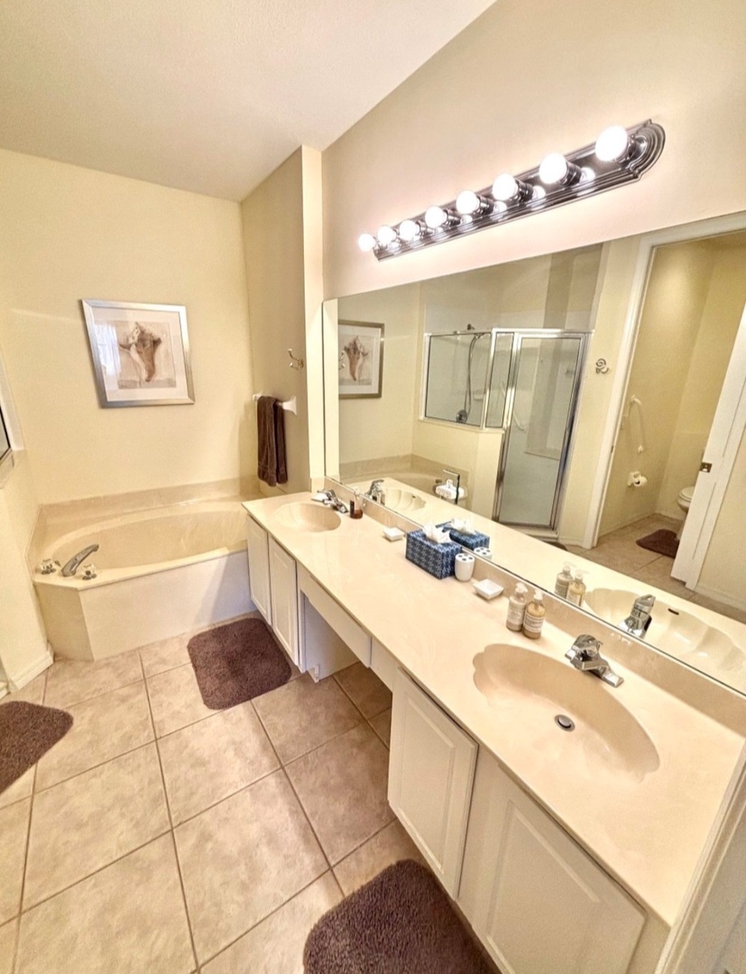 Unwind in your spacious bathroom with a relaxing soaking tub, separate shower, and vanity lighting perfect for your morning routine.