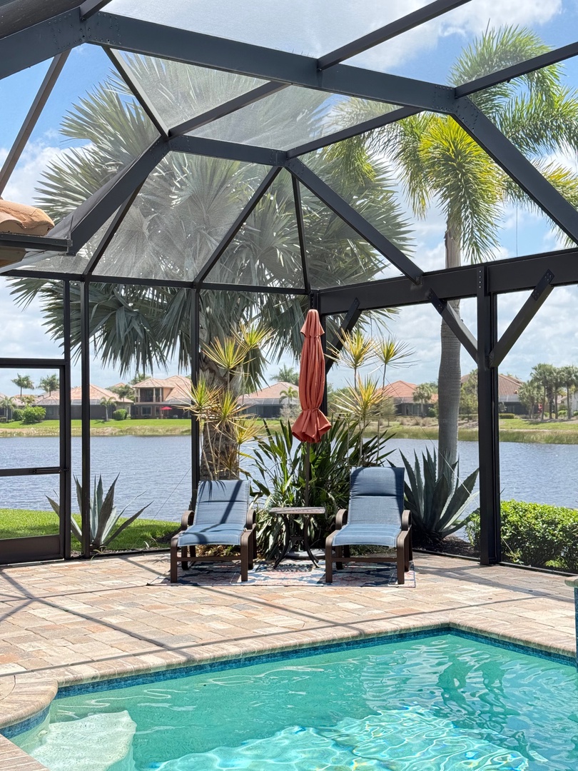 Step onto your private screened patio where tropical breezes meet poolside paradise. Relax in comfort while palm trees sway overhead.