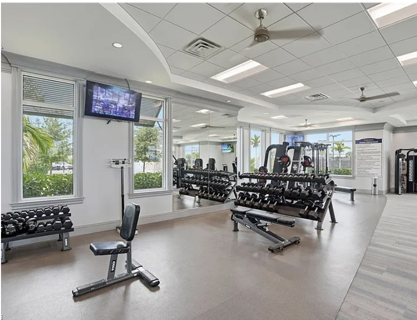 Step into your well-equipped fitness center, where bright natural light and modern equipment help you stay active during your vacation. Large windows overlook tropical palms while you work out.