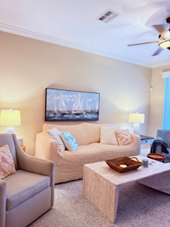 Your comfortable living space features soft seating, warm lighting, and a ceiling fan to keep you cool during your stay.