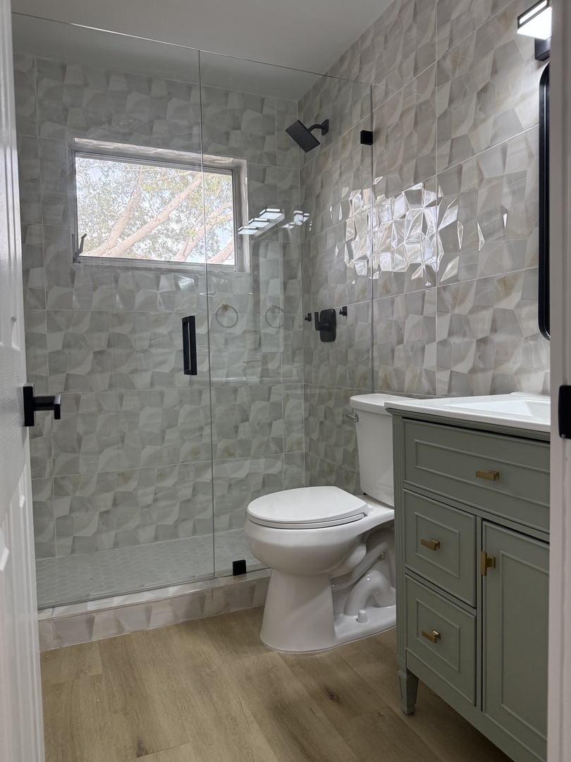 Second Shared bath. Step into your beautifully designed bathroom with elegant textured tiles, modern fixtures, and natural light streaming through the window.