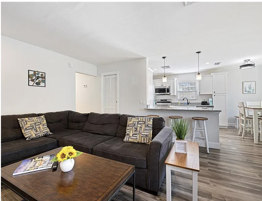 Settle into your spacious open-concept living area, where modern style meets comfort. Sink into the plush sectional, enjoy your morning coffee at the breakfast bar, or gather with loved ones around the bright, fully equipped kitchen.