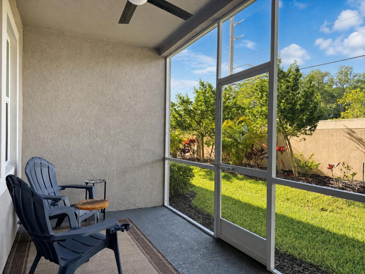Relax in your private screened patio with garden views, where morning coffee or evening unwind feels effortless amid lush greenery and peaceful surroundings.