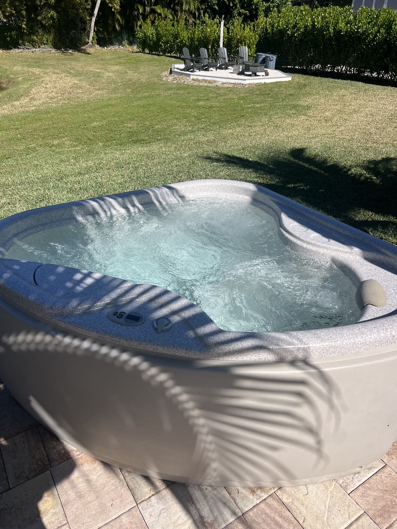 Soak away stress in your private hot tub, where bubbling jets and peaceful garden views create the perfect evening retreat.