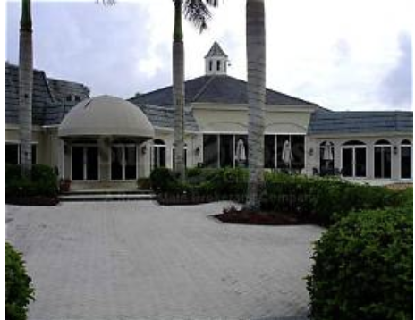 The property sits within a landscaped setting, featuring a classic architectural style with distinctive dome and cupola elements marking the entrance area.
