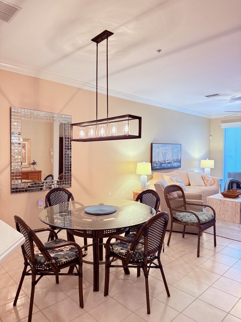 Gather around your private dining table with elegant cane-back chairs and enjoy meals together in this bright, open space that flows seamlessly into the kitchen.