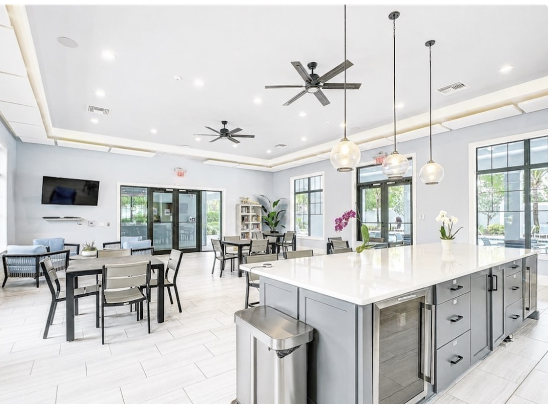 Gather around the spacious kitchen island or lounge at one of the dining tables—this bright, open communal area invites you to mingle, dine, and unwind in style.