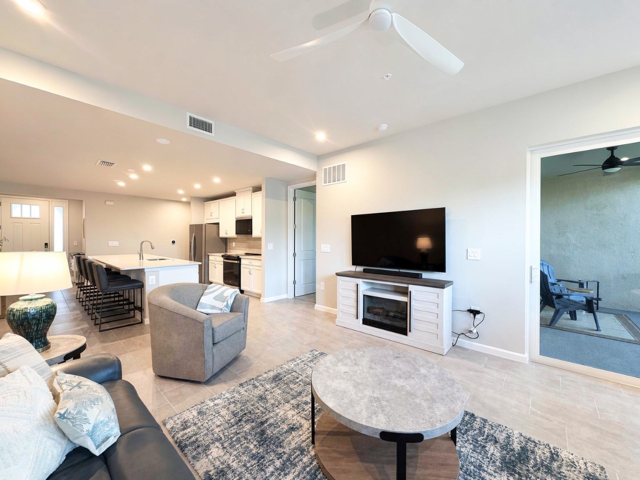 Step into your light-filled retreat with soaring ceilings and an open flow from the inviting living area through to the modern kitchen. Sink into the plush seating, enjoy your favorite shows, and feel right at home in this bright, comfortable space.