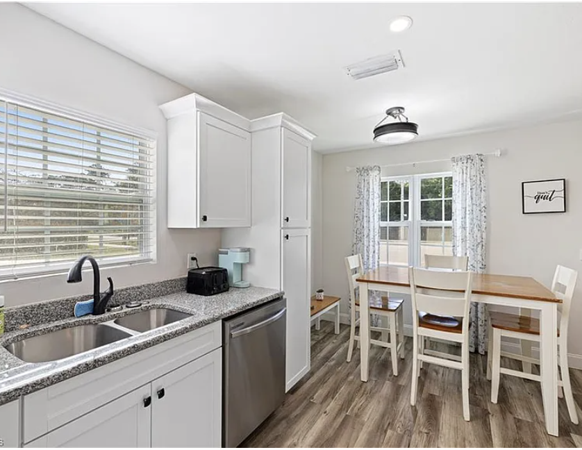 Your fully equipped kitchen awaits, complete with modern appliances and a cozy dining area bathed in natural light—perfect for morning coffee or home-cooked meals together.