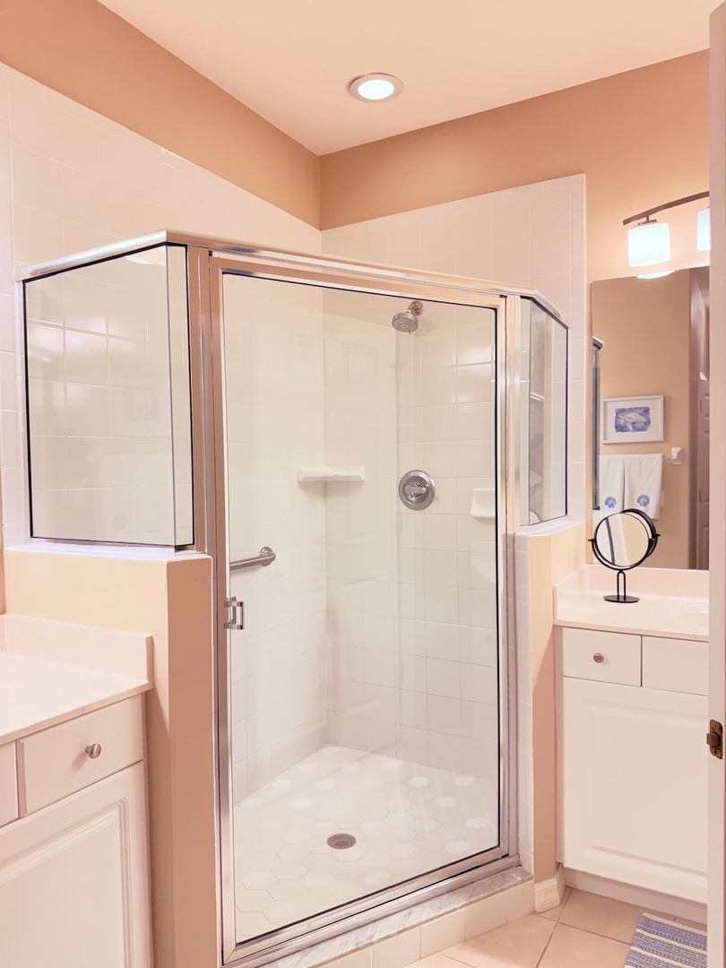 Step into your private oasis—a sparkling clean shower with a sleek glass enclosure and rainfall showerhead awaits, ready to refresh you after a day of adventure.