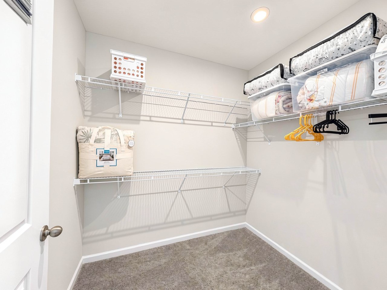 A thoughtfully designed walk-in closet with ample wire shelving and space for all your belongings, making unpacking and settling in effortless.