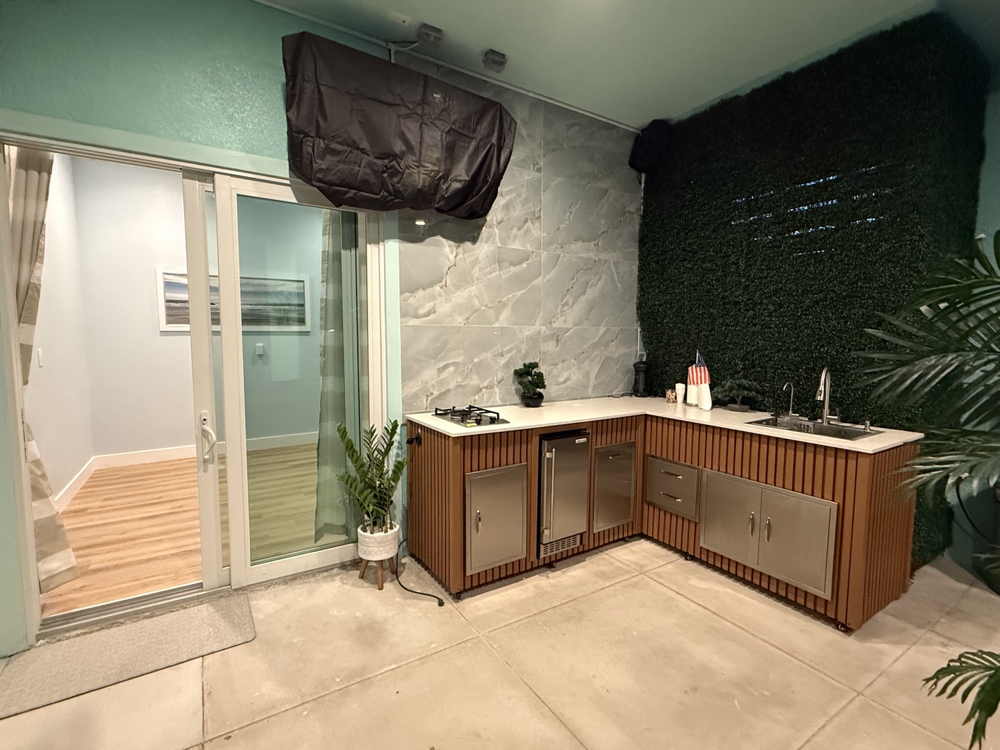 Your private outdoor kitchen awaits, complete with a sleek countertop, built-in storage, and modern fixtures—perfect for alfresco dining or sunset cocktails under the stars.