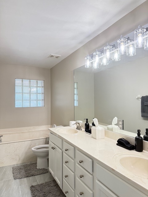Main bathroom Your elegant bathroom features dual vanities and a luxurious soaking tub, creating a perfect spa-like retreat for your morning routine.