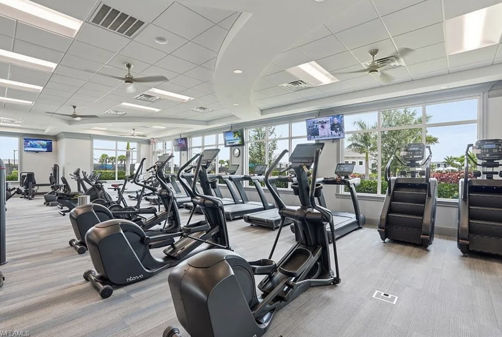 Your fitness routine continues in this bright, well-equipped gym with cardio machines and views of tropical greenery through floor-to-ceiling windows.