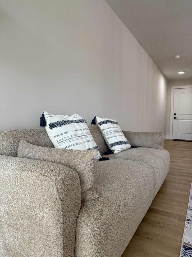 Sink into this plush sectional sofa with cozy throw pillows, perfect for your evening relaxation in the spacious living area.