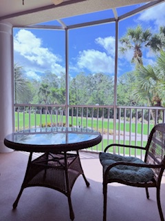 Enjoy your morning coffee on this screened-in patio, where you'll have peaceful views of the lush greenery and golf course surroundings.