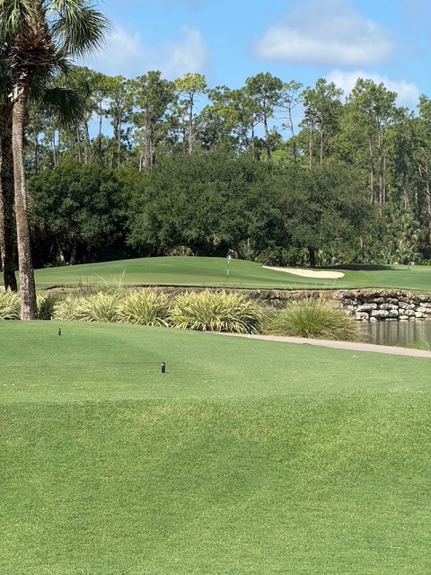 This property offers convenient proximity to pristine golf fairways, complemented by tropical landscaping and scenic natural surroundings under clear Florida skies.