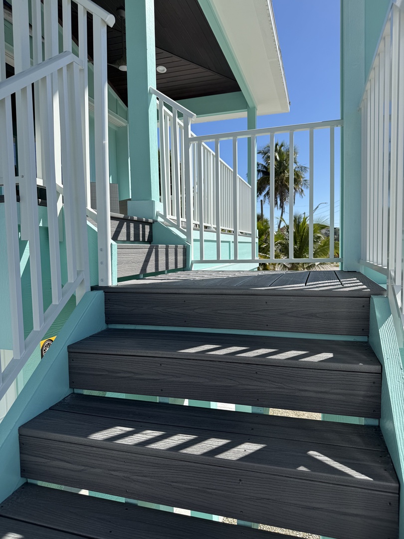 Your private balcony offers the perfect retreat with coastal breezes and tropical glimpses through stylish slat privacy.