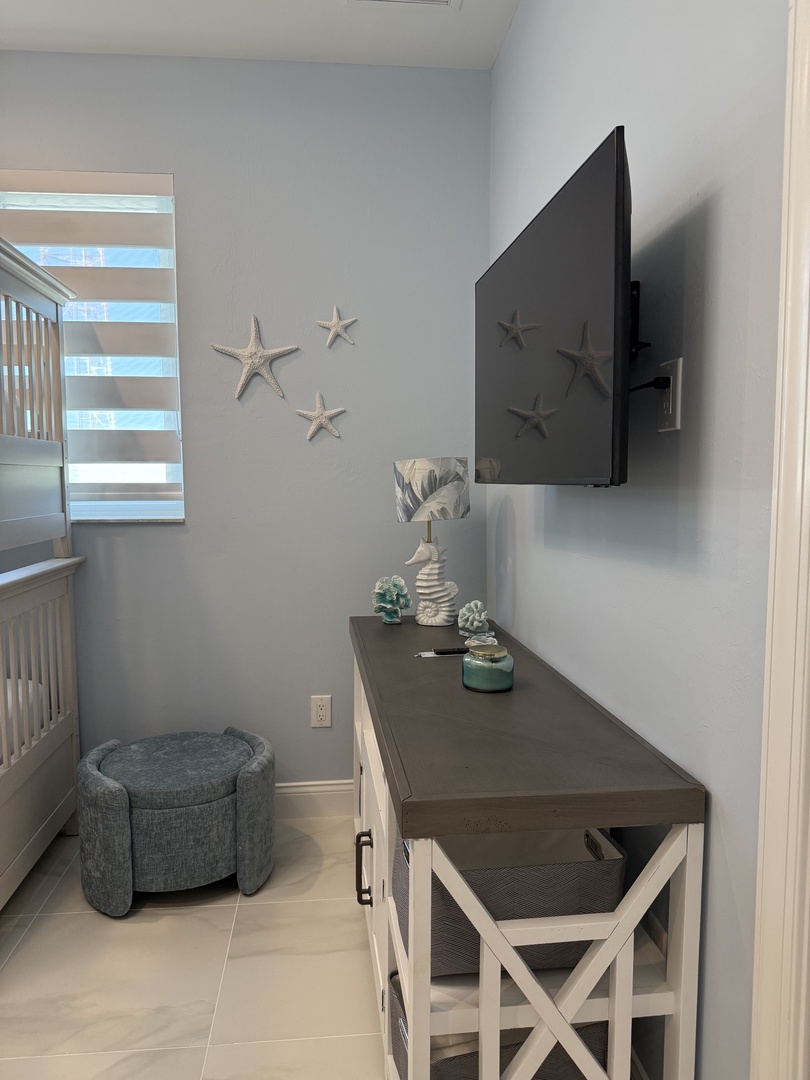 Relax in your coastal-themed living space where starfish wall art and ocean blues create a soothing retreat after beach days.