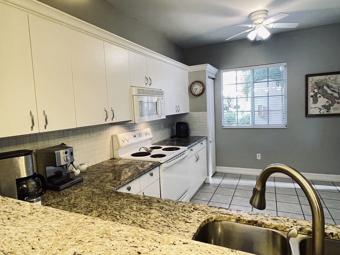 Your fully-equipped kitchen features granite counters, white cabinets, and everything you need to create memorable meals during your stay.
