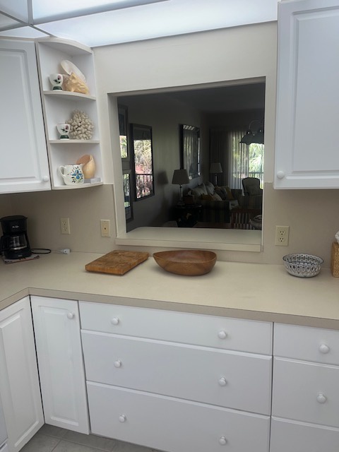 This bright, well-appointed kitchen opens gracefully into the living area, making it easy for you to cook, visit, and relax all at once. Clean counters and charming shelving give you both function and style.