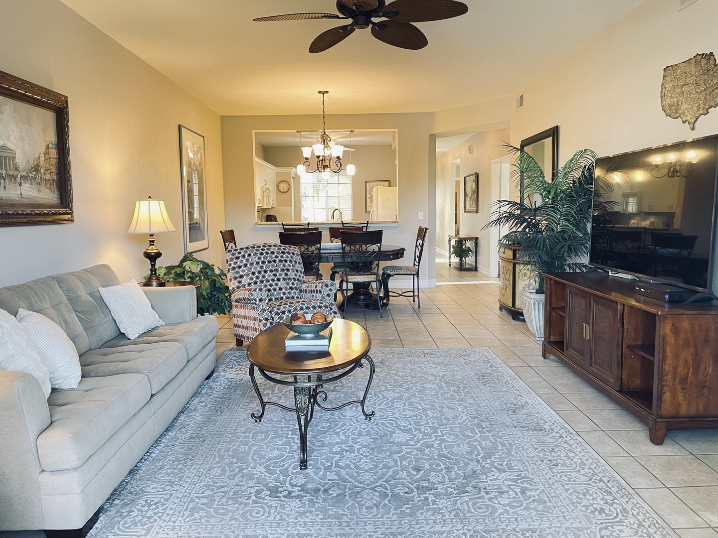 Relax in your spacious living area with plush seating, entertainment center, and open flow to the dining space for memorable gatherings.