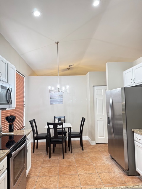 Your modern kitchen flows seamlessly into a cozy dining space with sleek appliances and warm lighting for memorable meals.