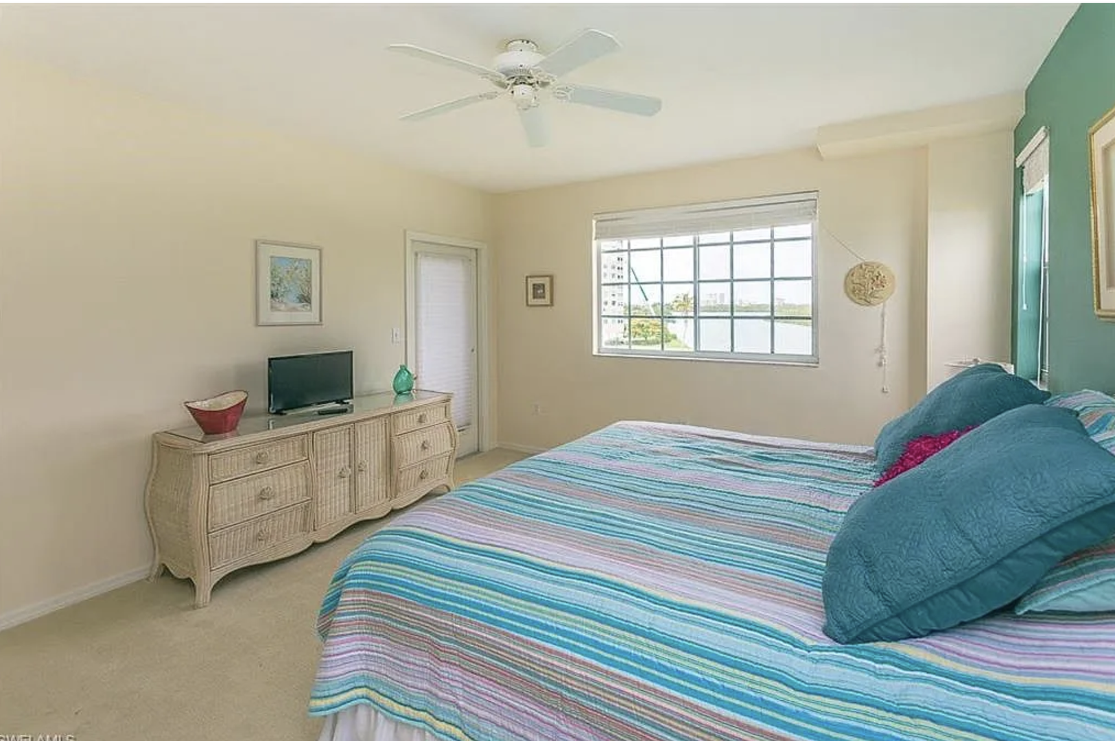 Drift off under gentle ceiling fan breezes in your calming coastal-inspired bedroom, where soft linens and soothing tones invite restful sleep after days spent by the water.