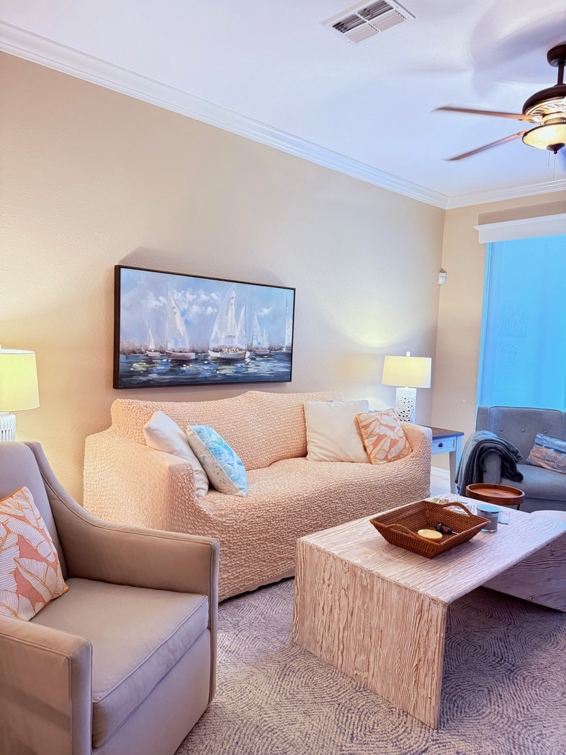 Sink into this inviting space where soft textures and coastal hues create your perfect retreat. The plush sofa and calming palette invite you to unwind after your beach adventures.