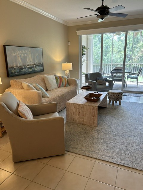 Sink into comfort in your welcoming living room, where natural light pours through the glass doors and leads to your private balcony surrounded by trees.