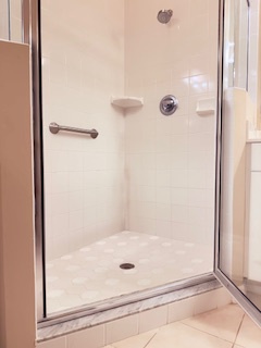 A walk-in shower with grab bar for safety and convenience, designed for your comfort and accessibility.