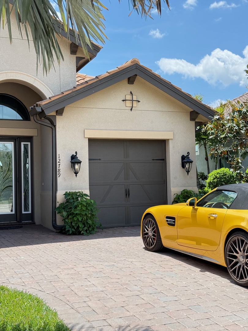 Beautiful property exterior with convenient parking and charming landscaping creates an inviting arrival experience.