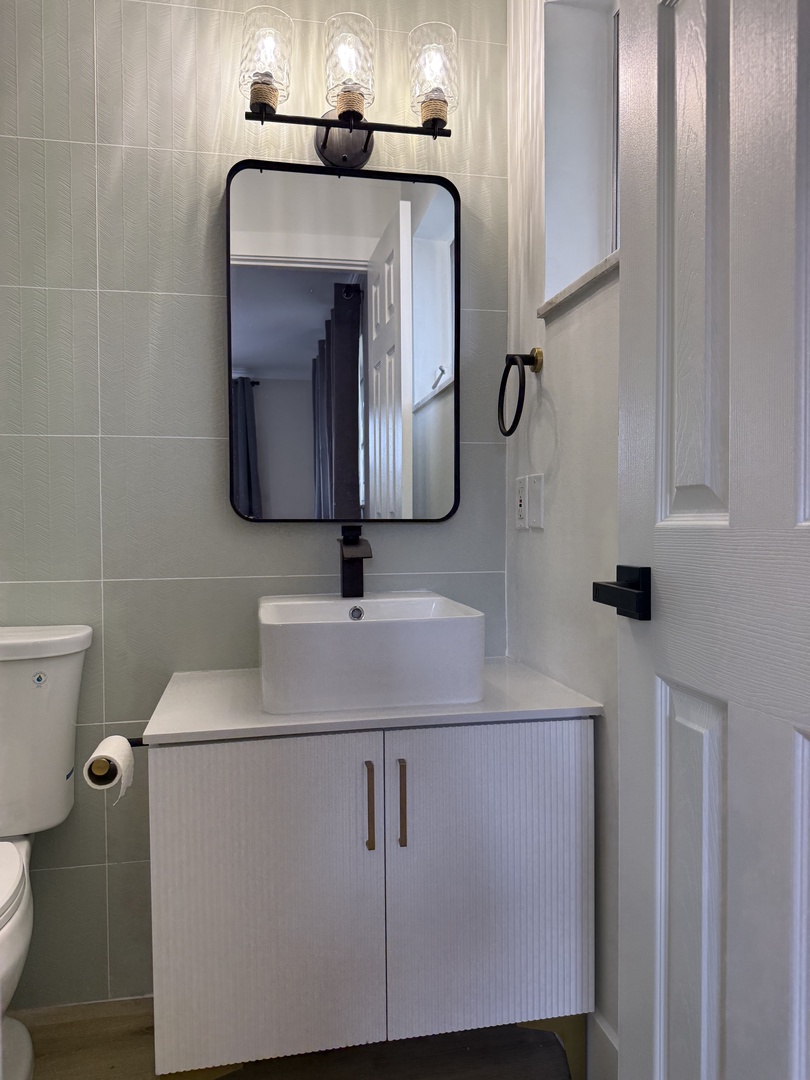 Private attached bathroom featuring a spacious walk-in shower, modern fixtures, and sleek tile work that creates a spa-like retreat.