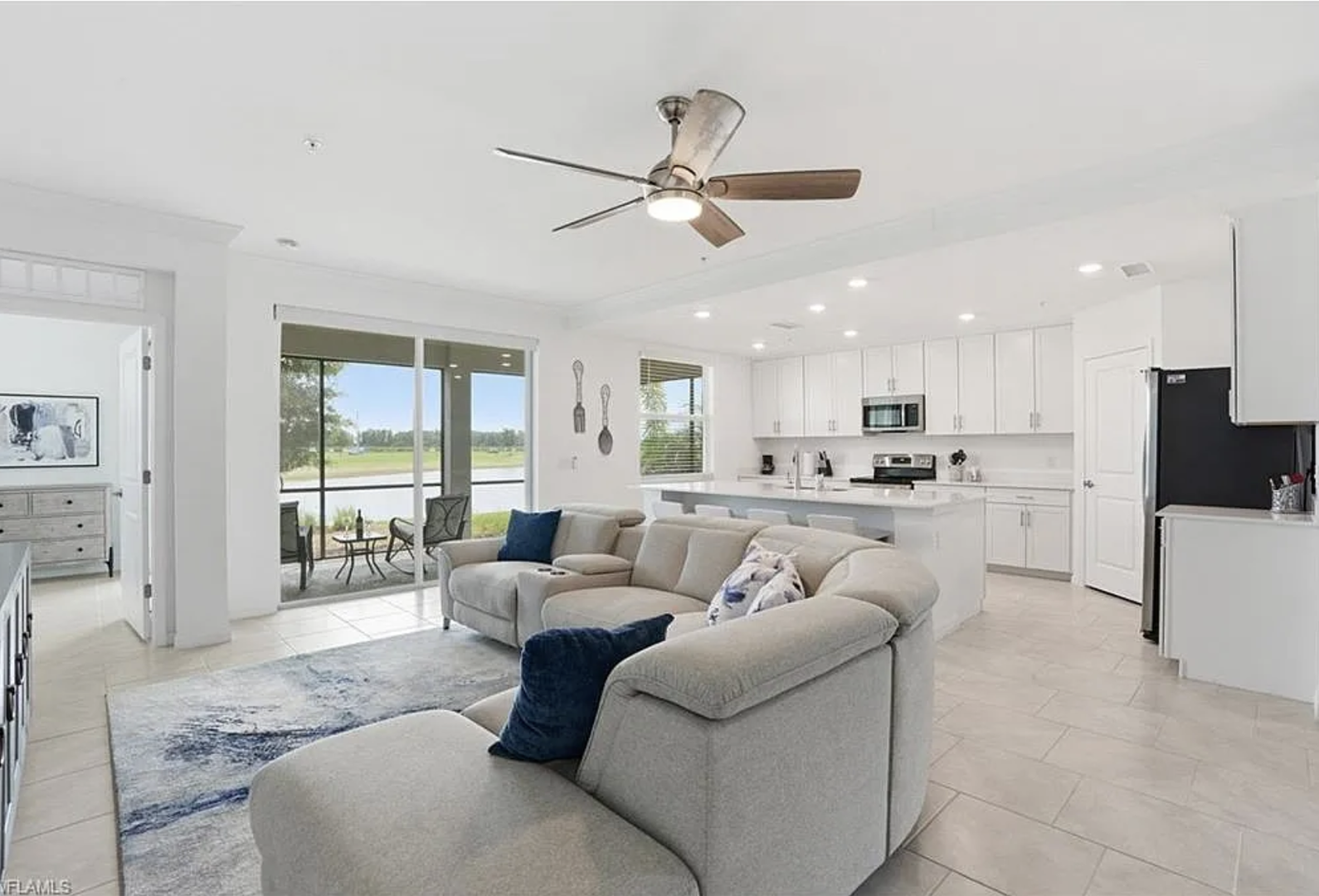 Relax in your open-concept retreat where coastal comfort meets modern design. Plush seating invites you to unwind while the full kitchen awaits your culinary adventures, and sliding doors beckon to your private outdoor patio.