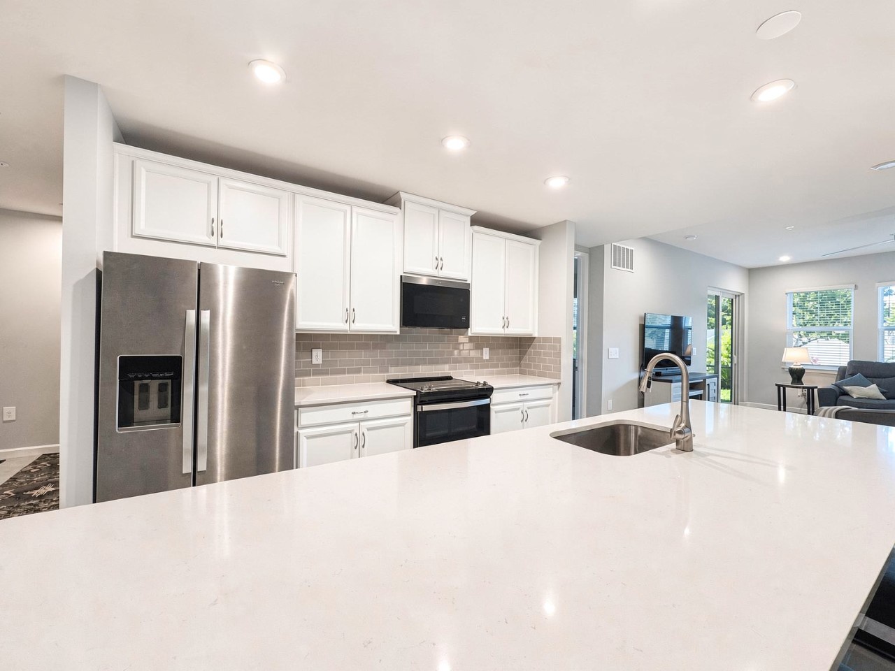 Cook and gather in your spacious modern kitchen, complete with gleaming quartz counters, stainless appliances, and an open flow into the bright living area—perfect for sharing meals and making memories.