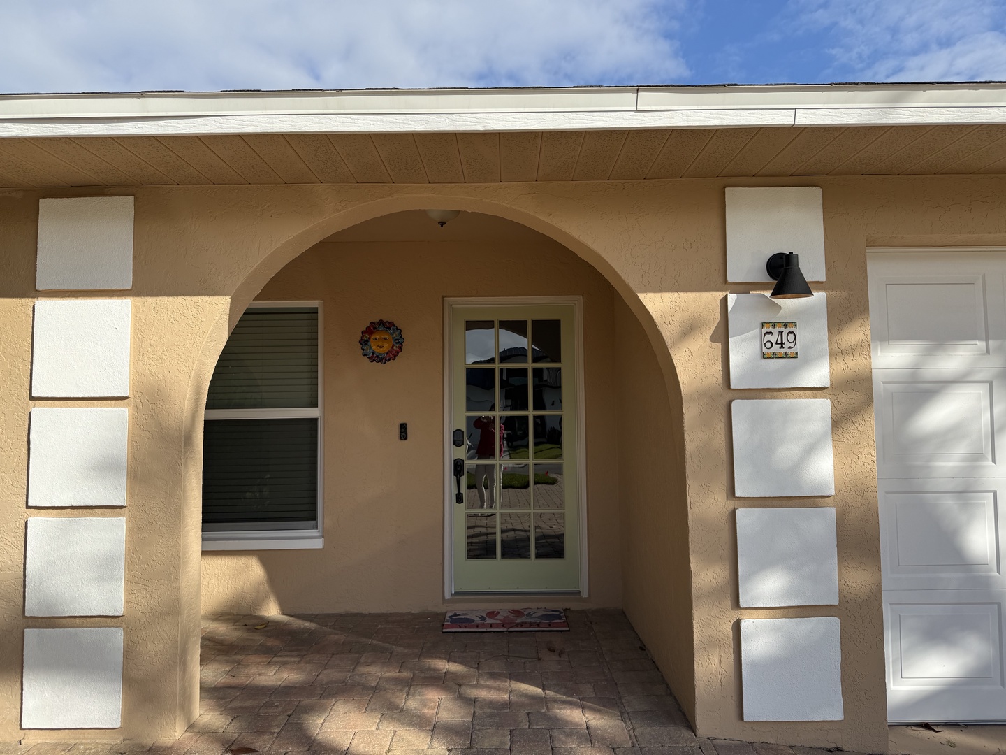 Property entrance with distinctive architectural design and decorative elements in a quiet residential setting.